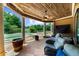 Relax on the outdoor patio with a ceiling fan, comfortable seating and poolside views at 932 Shadowford Fls, Lithonia, GA 30058