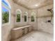 Arched shower with a built-in seat and three windows provides a spa-like experience at 932 Shadowford Fls, Lithonia, GA 30058