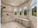 Arched shower with a built-in seat and three windows provides a spa-like experience at 932 Shadowford Fls, Lithonia, GA 30058