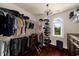 Spacious walk-in closet features custom shelving and a window with an outside scenic view at 932 Shadowford Fls, Lithonia, GA 30058