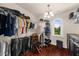 Bright walk-in closet features hardwood flooring, a window view, and custom shelving units at 932 Shadowford Fls, Lithonia, GA 30058