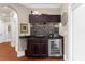 Wet bar features modern cabinets and bar sink, a wine cooler, and stylish backsplash at 932 Shadowford Fls, Lithonia, GA 30058