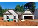 New home under construction with visible wood framing, windows, and roof against a bright blue sky at 494 Charleston Pl, Villa Rica, GA 30180