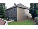 Back exterior view of the home with patio, dining set, and lush backyard at 4990 Arbor View Nw Pkwy, Acworth, GA 30101