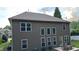 View of the home's rear exterior, featuring a table and chairs on a patio and many windows at 4990 Arbor View Nw Pkwy, Acworth, GA 30101