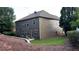 View of the home's rear exterior, featuring a table and chairs on a patio and gravel landscaping at 4990 Arbor View Nw Pkwy, Acworth, GA 30101