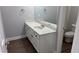 Bathroom with wood grain vinyl flooring, white vanity with sink, and large mirror at 4990 Arbor View Nw Pkwy, Acworth, GA 30101