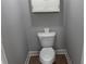 Powder room with a white toilet, cabinet above, and neutral paint at 4990 Arbor View Nw Pkwy, Acworth, GA 30101