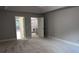 Large bedroom with multiple doorways, neutral paint, and soft carpeting at 4990 Arbor View Nw Pkwy, Acworth, GA 30101