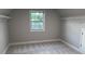 Carpeted walk-in closet with a window and shelving units at 4990 Arbor View Nw Pkwy, Acworth, GA 30101