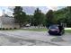 Image showcases the community pool with nearby parking, umbrellas, and a play area at 4990 Arbor View Nw Pkwy, Acworth, GA 30101