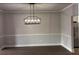 Spacious dining room with modern chandelier and light gray walls at 4990 Arbor View Nw Pkwy, Acworth, GA 30101