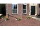 Attractive landscaping with red gravel and new shrubbery accents the front of the brick home at 4990 Arbor View Nw Pkwy, Acworth, GA 30101