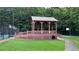 Community gazebo by a sidewalk and grassy area; tennis and basketball courts in the background at 4990 Arbor View Nw Pkwy, Acworth, GA 30101