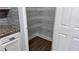 Pantry with white shelves next to granite countertop and white drawers at 4990 Arbor View Nw Pkwy, Acworth, GA 30101
