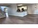 Open-concept kitchen with white cabinets, granite counters, hardwood floors, and view to living area at 4990 Arbor View Nw Pkwy, Acworth, GA 30101