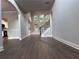 Spacious living room featuring hardwood floors, high ceilings, and a wall of windows overlooking the backyard at 4990 Arbor View Nw Pkwy, Acworth, GA 30101