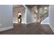 Open-concept living space with hardwood floors, stairs to the second floor, and view of the kitchen at 4990 Arbor View Nw Pkwy, Acworth, GA 30101