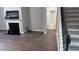 View of living room featuring hardwood floors, fireplace, and staircase to upper level at 4990 Arbor View Nw Pkwy, Acworth, GA 30101