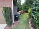 View of the side yard featuring a retaining wall, lush green grass, and landscaping at 4990 Arbor View Nw Pkwy, Acworth, GA 30101