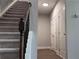 Carpeted staircase with dark wood railing and black balusters leads to upper level at 4990 Arbor View Nw Pkwy, Acworth, GA 30101