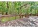 Wooden back deck overlooking a wooded area, featuring a ceiling fan for comfortable outdoor living at 1341 Little Deer Run, Canton, GA 30114