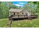 Backyard view showing a deck, siding, and grass with stepping stones for an enjoyable outdoor space at 1341 Little Deer Run, Canton, GA 30114