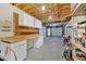 Spacious unfinished basement featuring bright lighting, a workbench area, storage, and access to the garage at 1341 Little Deer Run, Canton, GA 30114