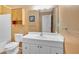 Bathroom featuring a large mirror, vanity with white cabinetry, and a toilet next to a tub-shower combo at 1341 Little Deer Run, Canton, GA 30114