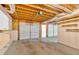 Large, unfinished garage with multiple doors, storage shelves, and exposed ceiling, ready for customization at 1341 Little Deer Run, Canton, GA 30114