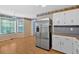 Eat-in kitchen area with a stainless steel refrigerator and a large window letting in natural light at 1341 Little Deer Run, Canton, GA 30114
