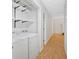 Laundry room with side by side washer and dryer and built in shelving at 1341 Little Deer Run, Canton, GA 30114