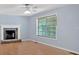 Cozy living room featuring a stone fireplace, hardwood floors, and ample natural light at 1341 Little Deer Run, Canton, GA 30114