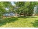 Expansive backyard featuring mature trees and lush green grass at 1348 Branchwood Dr, Snellville, GA 30078