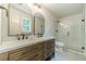 Bathroom with dual vanity, modern fixtures, and tiled glass shower at 1348 Branchwood Dr, Snellville, GA 30078