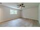 Spacious bedroom with light colored flooring, a ceiling fan, and double windows at 1348 Branchwood Dr, Snellville, GA 30078