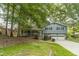 Traditional home with an inviting front porch, mature trees, and a two-car garage at 1348 Branchwood Dr, Snellville, GA 30078