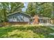 View of the house exterior showing the siding, chimney and backyard at 1348 Branchwood Dr, Snellville, GA 30078