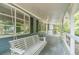 Relaxing front porch featuring a porch swing and white railing at 1348 Branchwood Dr, Snellville, GA 30078