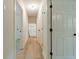 Neutral hallway showcasing new floors and doors with black hardware leading to various rooms at 1348 Branchwood Dr, Snellville, GA 30078
