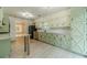 Updated kitchen boasting green cabinets, granite countertops, stainless appliances and a breakfast bar at 1348 Branchwood Dr, Snellville, GA 30078