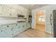 Updated kitchen featuring green cabinets, granite counters, stainless steel appliances, and views into the living room at 1348 Branchwood Dr, Snellville, GA 30078