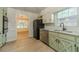 Updated kitchen with stainless appliances, granite counters, and views into the living room with abundant natural light at 1348 Branchwood Dr, Snellville, GA 30078