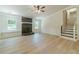 Open-concept living room with a stone fireplace and stairs leading to the upper level at 1348 Branchwood Dr, Snellville, GA 30078