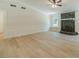 Bright living room featuring light wood floors, wainscoting, and a stone fireplace at 1348 Branchwood Dr, Snellville, GA 30078
