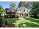 A spacious, grassy backyard featuring a deck, swing and well-manicured lawn at 2208 Mountain Springs Nw Ct, Kennesaw, GA 30144