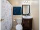 Bathroom with a patterned shower curtain and dark wood vanity at 2208 Mountain Springs Nw Ct, Kennesaw, GA 30144