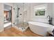 A stunning bathroom with a soaking tub and glass shower adjacent to the bedroom at 2208 Mountain Springs Nw Ct, Kennesaw, GA 30144