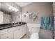 Bathroom featuring white cabinets, black granite countertops and a large framed mirror at 2208 Mountain Springs Nw Ct, Kennesaw, GA 30144
