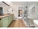 This elegant bathroom features double sinks, a glass enclosed shower, and neutral colors at 2208 Mountain Springs Nw Ct, Kennesaw, GA 30144